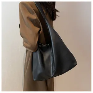 Detail of black large capacity hobo bag featuring premium pebble grain leather texture