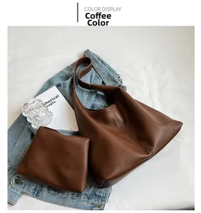 Detail of coffee brown leather tote bag with pebble grain texture and matching pouch