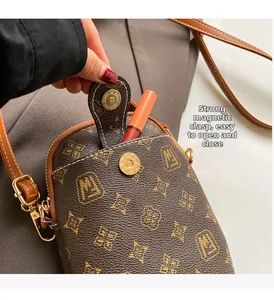Close-up of vintage monogram phone bag with strong magnetic buckle and lipstick storage