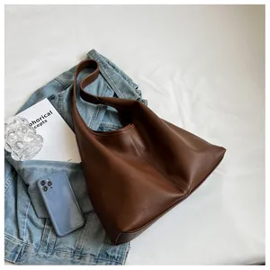Close-up of chocolate brown large capacity tote bag with premium lychee grain leather texture