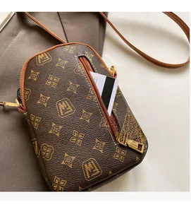 Detail view of the front zipper pocket on a vintage monogram mini crossbody phone bag