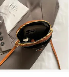 Top view of mini crossbody bag interior showing space for smartphone and lipstick