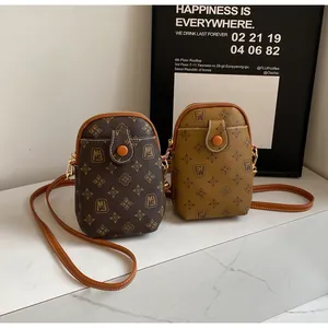 Classic monogram mobile phone bags in brown and yellow on marble surface detail
