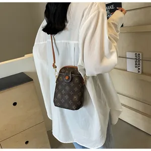 Close-up of retro monogram mobile phone bag in brown faux leather with MJ flower pattern