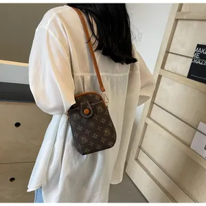Detail of vintage monogram mini shell crossbody bag with adjustable leather strap
