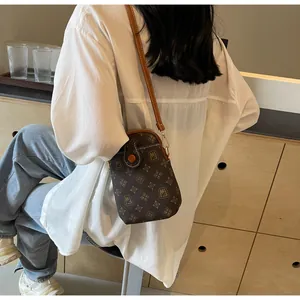 Mini brown monogram shell bag styled with white shirt and blue jeans for a casual look