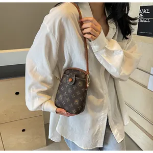 Detail of vintage monogram mini phone bag with MJ pattern and brown leather strap