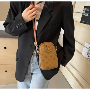 Brown vintage monogram mini crossbody phone bag with adjustable strap on model