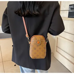 Rear view of a mini brown monogram crossbody phone bag with adjustable shoulder strap