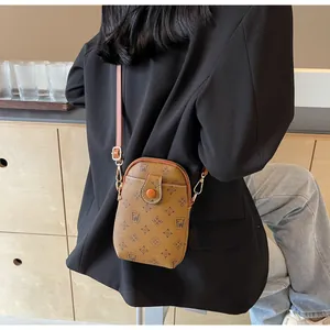 Detailed view of vintage monogram phone bag with adjustable leather strap and gold hardware