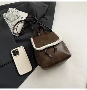 Nahaufnahme des braunen Lederrucksacks mit weißem Webpelzbesatz und Kordelzug-Detail