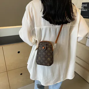 Vintage dark brown shell bag with MJ monogram print and adjustable shoulder strap