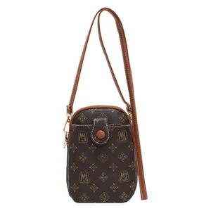 Vintage monogram mini crossbody phone bag with brown strap and magnetic buckle