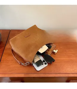 Top view of brown suede shoulder bag showing spacious interior with personal essentials
