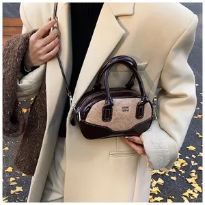 Detail of retro color-block bowling bag with tweed textures and leather straps
