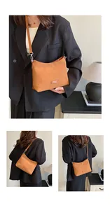 Detail of caramel brown matte shoulder bag with silver nameplate and adjustable strap