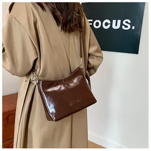 Brown faux leather square bag shown on model for size and style perspective