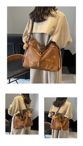 Detail of vintage brown tote bag with plush bear charm and retro matte leather texture