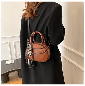 Detail of brown PU leather crossbody bag featuring unique 36 tag and side knot accents