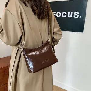 Vintage dark brown glossy square shoulder bag with adjustable strap and minimalist design