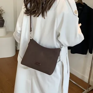 Retro deep brown suede trapezoid shoulder bag with minimalist design for women