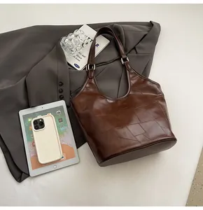 Detail van de vintage bruine tote bag met geometrische stiksels en verstelbare gesp