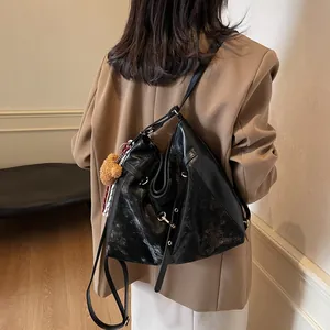 Fashionable black faux leather backpack for women shown with cute bear pendant charm