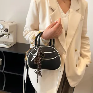 Minimalist black and white baseball bag with stylish contrast trim and crossbody strap
