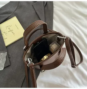 Top view of brown lychee leather bucket bag showing spacious interior and silver hardware