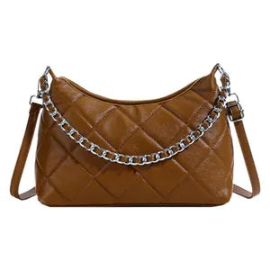 Brown quilted crossbody bag with silver chain detail and adjustable strap on white background