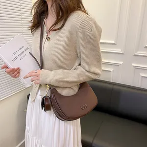 Dark brown crescent leather shoulder bag with mini pouch in a retro chic style