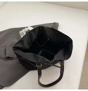 Interior view of large tote bag showing zipper pocket and adjustable leather handles
