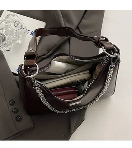 Interior view of deep brown underarm bag with silver chain and spacious compartments