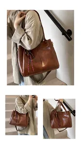 Dettaglio borsa tote marrone vintage con tracolla larga intrecciata e rimovibile