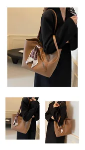 Detail of brown litchi leather tote bag with elegant silk scarf and stitched front pocket