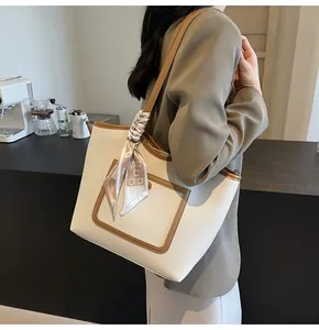 Litchi texture off-white tote bag with brown trim and decorative scarf detail