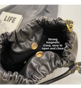Detail of the black cloud bag showing the strong magnetic buckle and gold hardware