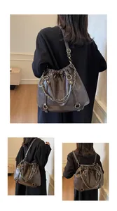 Detail of vintage brown pleated PU leather bag showing shoulder and backpack carry modes