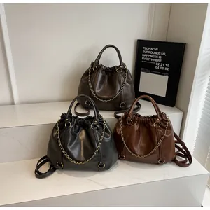Detailed display of three pleated PU leather handbags in black, brown and caramel colors