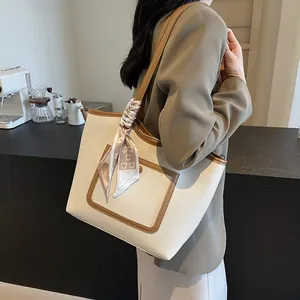 Contrast color tote bag in off-white pebbled leather with printed silk scarf detail