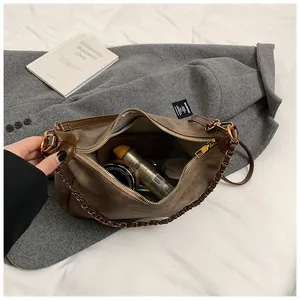 Interior detail of brown suede tote bag showing spacious capacity for cosmetics and items