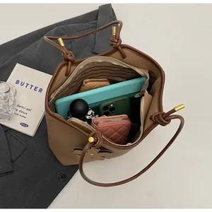 Internal view of brown bucket bag showing space for tablet, phone and umbrella
