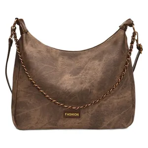 Vintage brown faux suede hobo bag with metal plate and adjustable strap