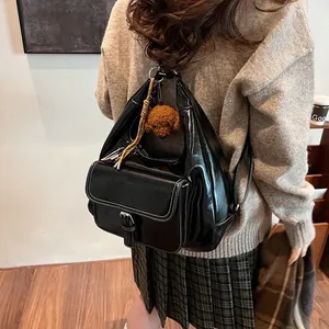 Chic black oil wax leather shoulder bag with front flap pocket and cute teddy charm