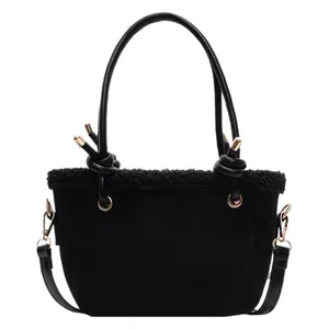 Vintage matte black bucket bag with plush shearling trim and stylish knotted handles