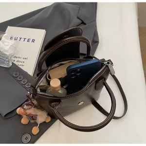 Detailed view of brown pleated handbag interior capacity with daily essentials
