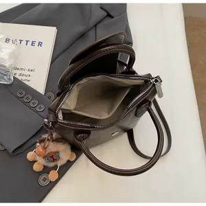 Interior view of deep brown pleated handbag showing spacious main compartment and lining