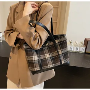 Detail shot of vintage plaid tote bag with brown tweed fabric and faux leather straps