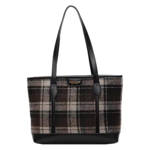 Retro plaid tote bag in brown and black fabric with durable leather handles on white background