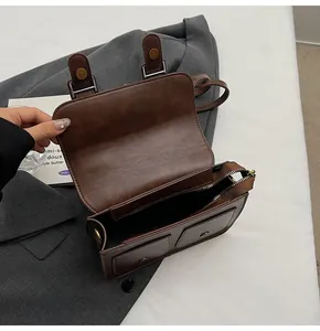 Top view of dark brown vintage satchel showing interior zipper and matte leather texture